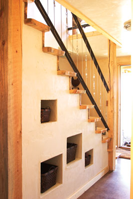 The stairway niches were inspired by a photo the couple found in a French home magazine. Emmanuelle picked up these baskets at Pier One, and they designed the stairway around them